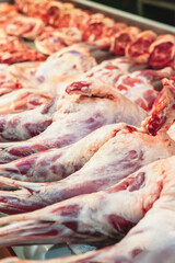 hind leg of the sheep is prepared for sale. Showcase of a butcher's shop with meat lamb