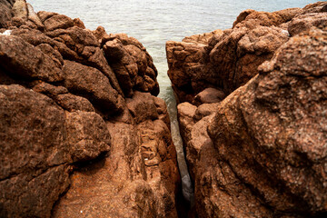 landscape with Spray of water by struck Seawater through tunnel between rocks