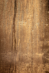 Drops of water on a glass window at dawn as an abstract background.