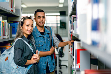 Colegas estudando em biblioteca.