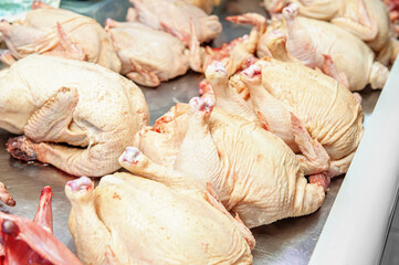Fresh homemade chicken carcass on the counter of the meat pavilion, raw chicken carcasses sold in the market counter.