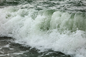 Wave in the sea with splashing water.