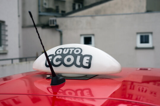 closeup of french driving school panel on the car roof , text in french "auto ecole", traduction in english "driving school"