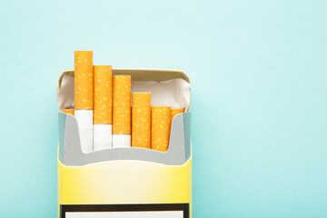 Pack of cigarettes on blue background. No smoking.