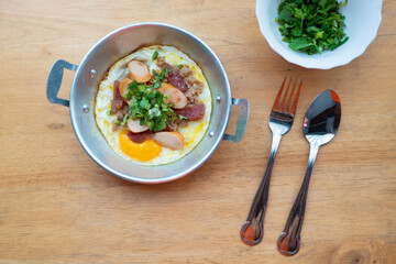 Breakfast, eggs, pans on a wooden table