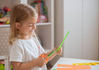Child teaching scissors skills - happy toddler playtime.