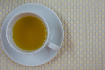 Tea in a white glass on the table