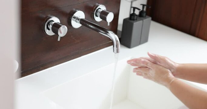 Woman washing hands rubbing with soap, Corona virus prevention, Hygiene practices to stop the spread of germs.
