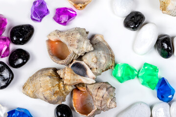 Fototapeta na wymiar Bright background of their colored stones and seashells.