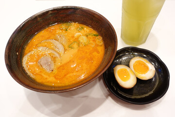 Shoyu ramen, Japanese noodle with pork, soft boiled egg and seaweed on the wooden table