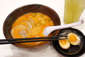 Shoyu ramen, Japanese noodle with pork, soft boiled egg and seaweed on the wooden table