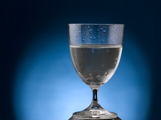 glass of water. Isolated on blue bacground