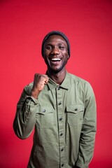 Young Black Man Smiling with Win Hand Gesture