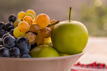white bowl with some autumn seasonal fruits