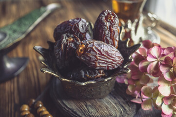 Royal gold Cup with dates for tea. Oriental holiday table, Oriental sweets for tea