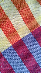 Orange and Purple loincloth texture with orange and purple gingham seamless pattern, abstract plaid, Texture background for Loincloth or Thai bathing cloth.