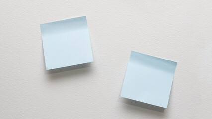Blue paper on white wall mock-up.