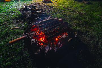 Grilled vegetables, meat and sausages. Cooking at the camping. Heat, coals. Summer night. Dinner on the hike. Food and tourism concept
