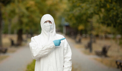 Doctor man in medical suit sterile face mask gloves on street . Epidemic pandemic coronavirus...