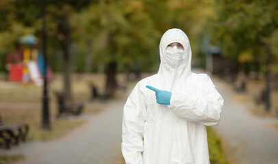 Doctor man in medical suit sterile face mask gloves on street . Epidemic pandemic coronavirus...