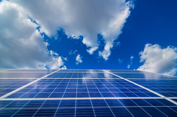 Solar energy panel power system, view up on and sky with clouds