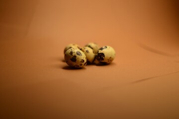 Quail eggs on brown background
