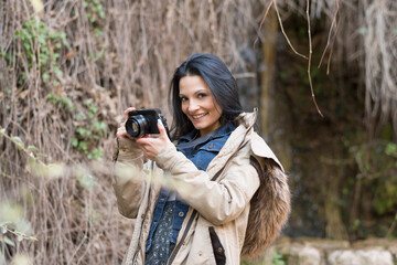 Woman with smartphone and camera in 