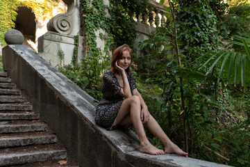 Portrait of a young girl in a green park