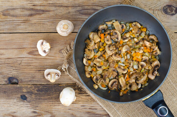 Frying pan with fried mushrooms, vegetarian dishes