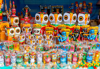 Fototapeta na wymiar A collection of colorful handmade traditional wooden owl sculpture and toys are displayed for selling in handicraft fair.
