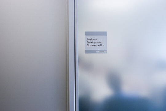 Sign Board On Glass Door Of Board Room At Office