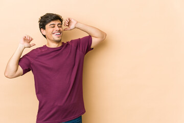 Young cool man stretching arms, relaxed position.
