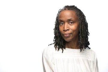 Portrait of middle aged black woman looking at camera with straight face 