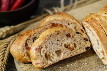 Sliced rye wheat baguette closeup with pepperoni