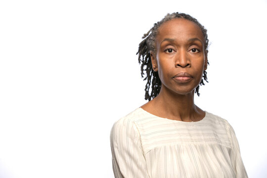 Portrait of middle aged black woman looking at camera with straight face