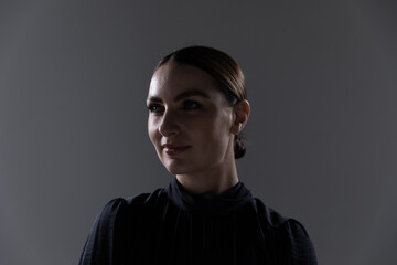 Young woman against grey background