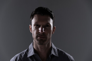 Portrait of young man against grey background