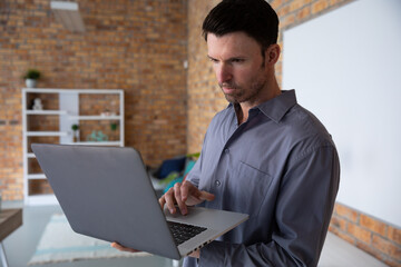 Man using laptop while standing