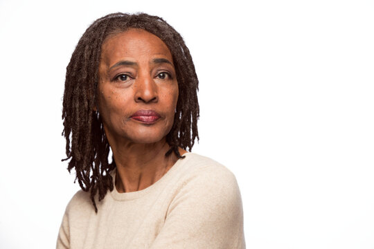 Portrait Of Older Black Woman Looking At Camera Over Shoulder With Straight Face 