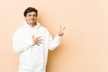 Young cool man taking an oath, putting hand on chest.