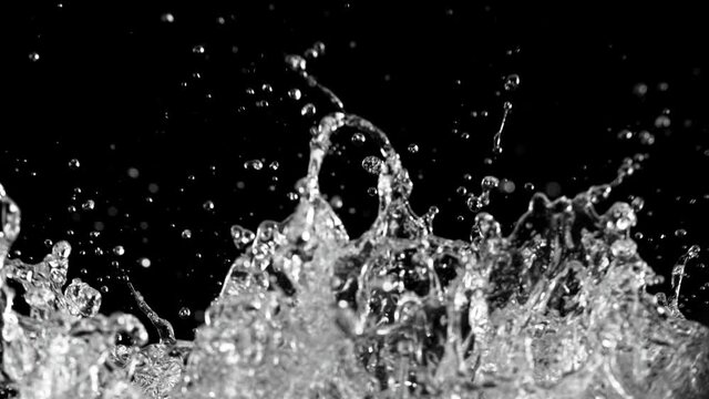 Super slow motion of splashing water, black background. Filmed on high speed cinema camera, 1000fps.