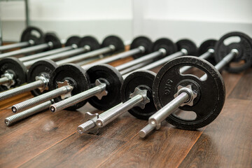 barbells for training lie on the floor in the gym