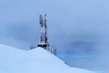 Balea lake, Transfagarasan, radio station surrounded by snow. Romania.