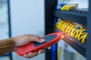 Network tester tools and system administrators will test the network cable in technogy data center...