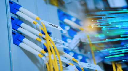 Yellow fiber optic cable with lighting of fiber optics and high speed network router switch in a...