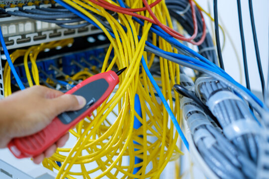 Network tester tools and system administrators will test the network cable in technogy data center room.