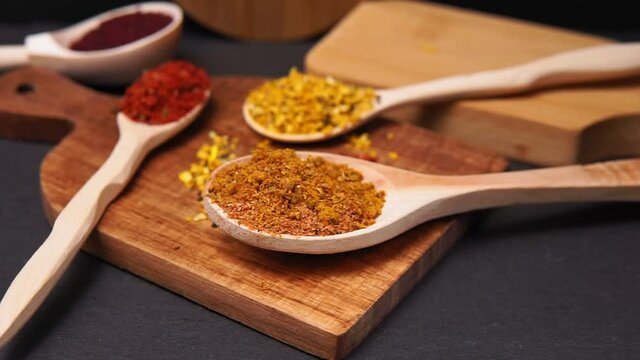spices in a wooden bowl close-up on a brown wooden background. selective focus