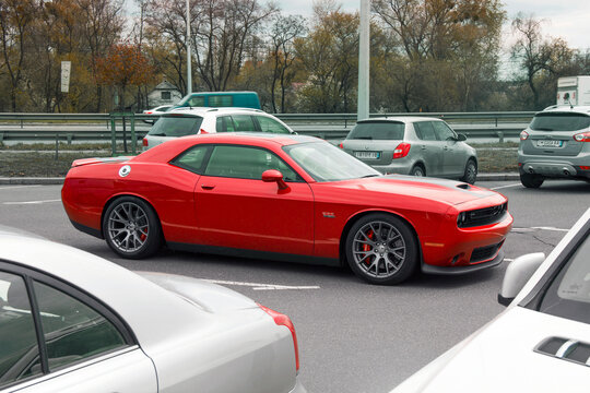 Kiev, Ukraine - April 21, 2020: Muscle car Dodge Challenger SRT8 392 HEMI in a parking lot among cars. Red car