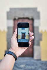 Hand Taking Photo Of Old European Door