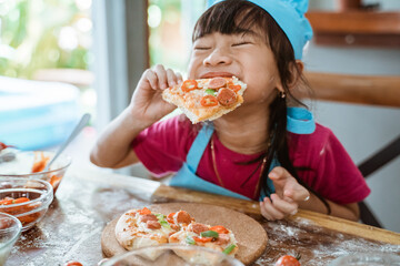 Little child girl eating pizza slices as symbol of best food after make it